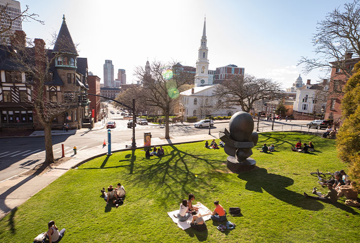 Student sitting in grass. Links to Gifts from Retirement Plans Student sitting in grass. Links to Gifts from Retirement Plans